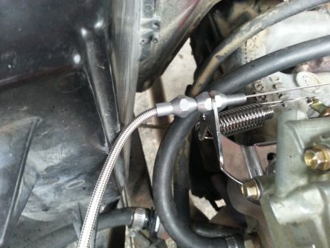 1981 Ford Bronco - Close-up view of a throttle cable assembly connected to a carburetor, with visible Supermotors.net branding.