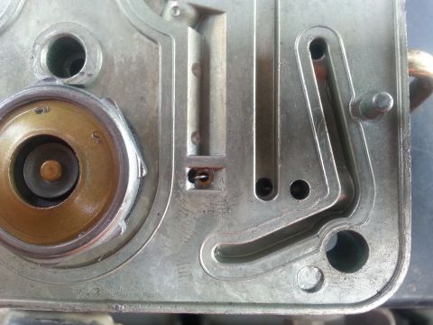 1981 Ford Bronco - This image shows a close-up view of a Holley carburetor, focusing on its internal components and fuel passages.