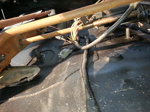 1994 Ford Bronco - Close-up of seat mounting hardware and electrical wiring beneath a vehicle seat.