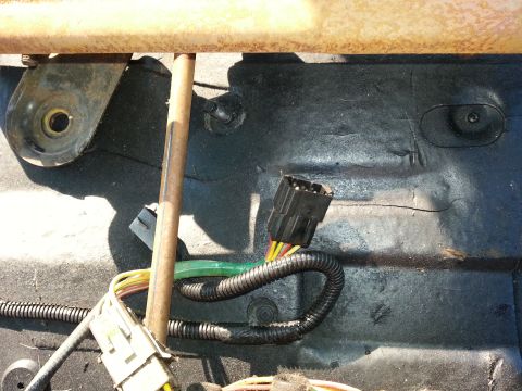 1994 Ford Bronco - This image shows the wiring harness and connector beneath a vehicle seat, not the seat itself.
