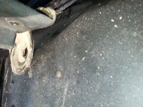 1994 Ford Bronco - Close-up of an interior metal surface with a mounting bracket and Supermotors branding.