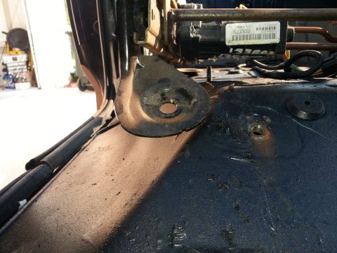 1994 Ford Bronco - Close-up of a seat mounting bracket and wiring harness, showing a label with the number 62009.