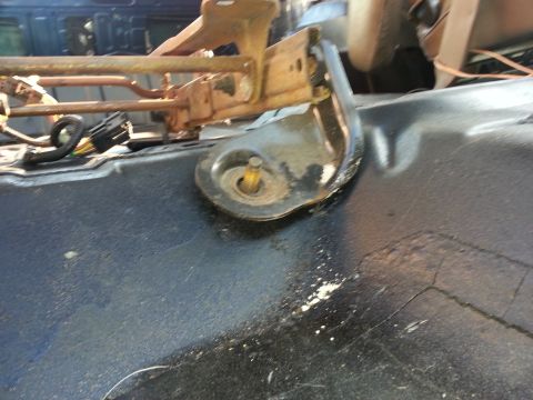1994 Ford Bronco - Vehicle seat mounting bracket detail, showing rust and wear on metal components.