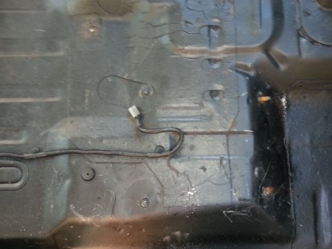 1994 Ford Bronco - Vehicle floor pan detail with electrical wiring harness visible.