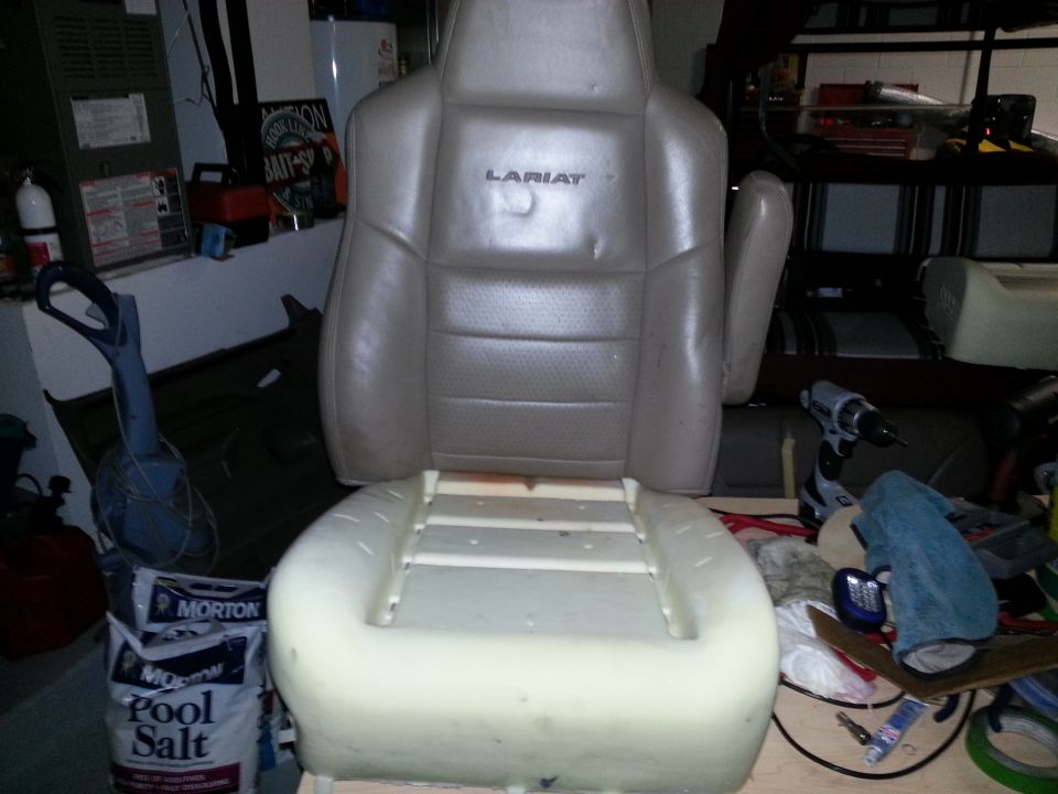 Leather car seat with Lariat trim, foam base exposed. Tools and bags of pool salt visible in background