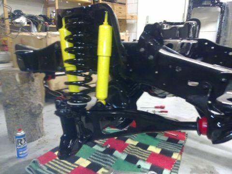 1984 Ford Bronco - Front suspension components, likely for a truck or SUV, are shown during a rebuild process.