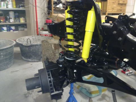 1984 Ford Bronco - This image shows a close-up of a vehicle's suspension and brake assembly, likely during a rebuild or repair.