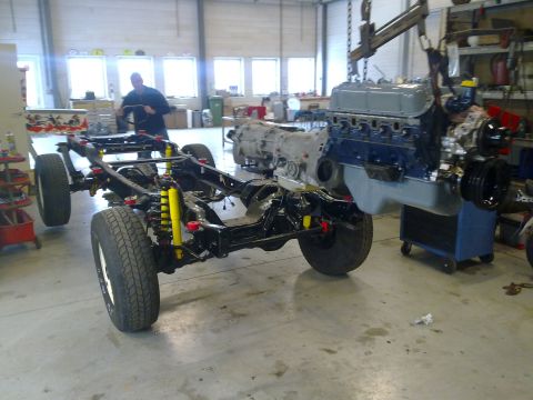 1984 Ford Bronco - Chassis rebuild in progress with engine and transmission assembly being installed.