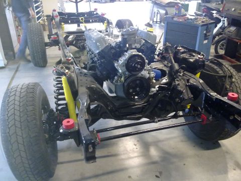 1984 Ford Bronco - The chassis of a vehicle is shown with its engine and suspension system during a rebuild.