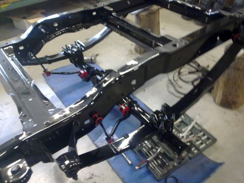 1984 Ford Bronco - Chassis rebuild in progress, showing the frame and suspension components.