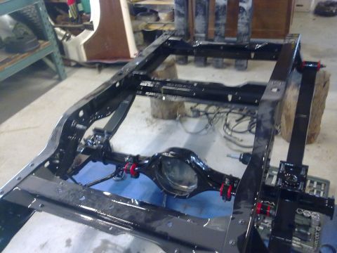 1984 Ford Bronco - The chassis of a vehicle is shown, with the rear axle and suspension components visible.