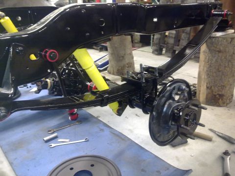 1984 Ford Bronco - Close-up of vehicle chassis and suspension parts during a rebuild.