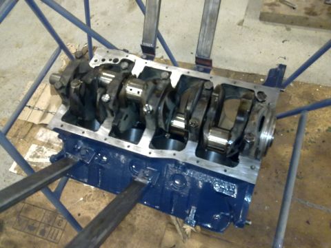 1984 Ford Bronco - Engine block assembly with crankshaft and connecting rods visible, painted blue.