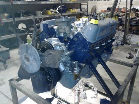 1984 Ford Bronco - Ford V8 engine assembly on a stand, likely undergoing rebuild or preparation.