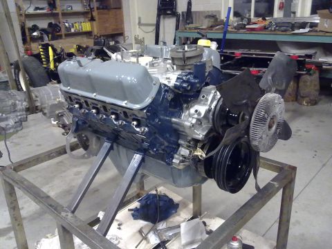 1984 Ford Bronco - Engine assembly on a stand in a workshop setting.