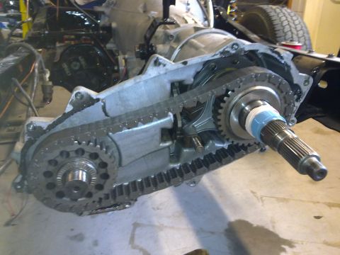 1984 Ford Bronco - Transfer case assembly with internal gears and drive chain exposed during rebuild.