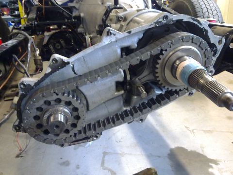 1984 Ford Bronco - Close-up view of a vehicle's transfer case, showing the internal chain and gear mechanism.
