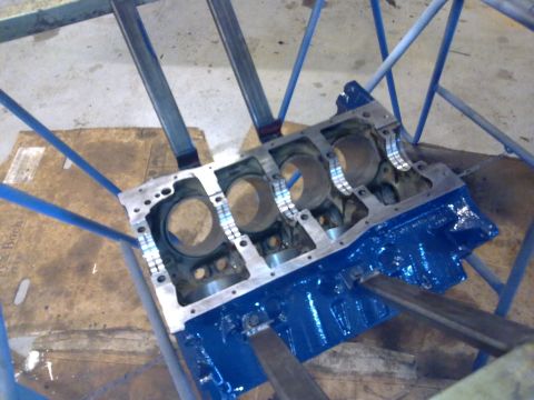 1984 Ford Bronco - Engine block undergoing rebuild, mounted on a stand for service.