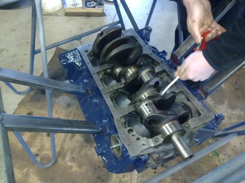 1984 Ford Bronco - Close-up of an engine block and crankshaft assembly during a rebuild process.