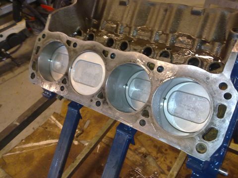 1984 Ford Bronco - Engine block with pistons, likely undergoing rebuild or maintenance.