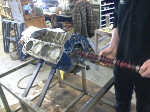 1984 Ford Bronco - Mechanic installs a camshaft into an engine block during a rebuild.