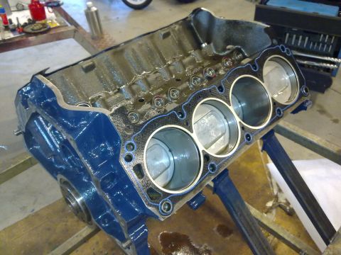 1984 Ford Bronco - Engine block assembly with pistons visible inside the cylinders, ready for further work.