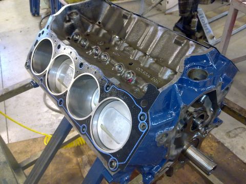 1984 Ford Bronco - Engine block with pistons visible, undergoing rebuild.