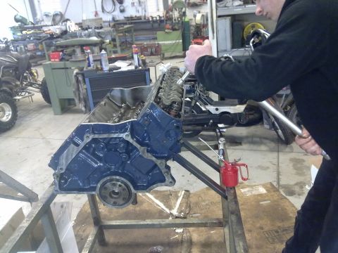1984 Ford Bronco - Engine block being worked on in a garage setting. The registry claims it is a 1984 Ford Bronco, but this is unconfirmed.