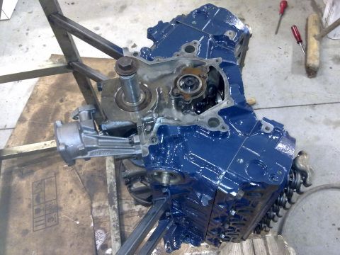 1984 Ford Bronco - Engine block, painted blue, is mounted on a stand for rebuilding. Tools are visible in the background.