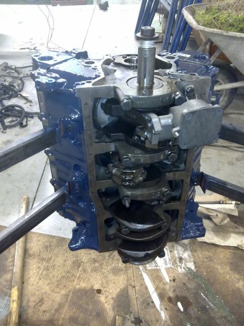 1984 Ford Bronco - Engine block with crankshaft and internal components exposed, undergoing rebuild.