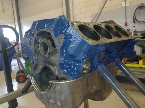 1984 Ford Bronco - A blue engine block is shown on a stand, ready for further work or assembly.