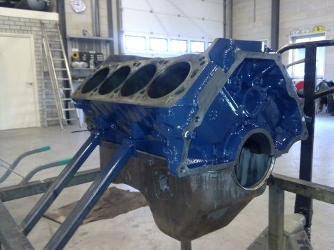 1984 Ford Bronco - A freshly painted V8 engine block sits on a stand, ready for assembly.