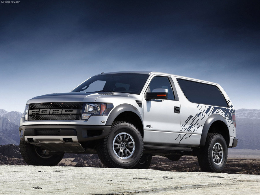 Custom SUV with Ford Raptor front end and Bronco-like rear bodywork, parked on dirt