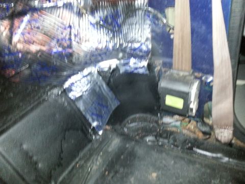 1994 Ford Bronco - The interior shows sound deadening material applied to the floor and a seatbelt assembly.