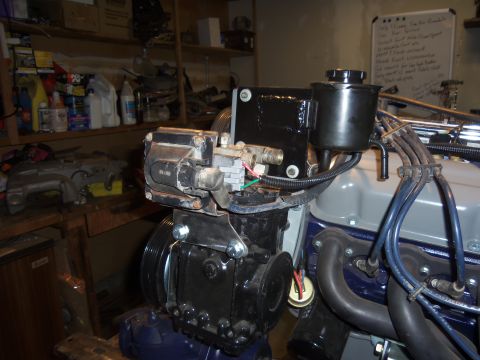 1968 Ford Bronco - Close-up view of an engine component, possibly part of a power steering system, with visible wiring and hoses.