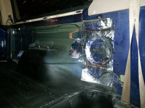 1994 Ford Bronco - The interior of a vehicle shows sound deadening material being applied to the side panel, obscuring the original interior.