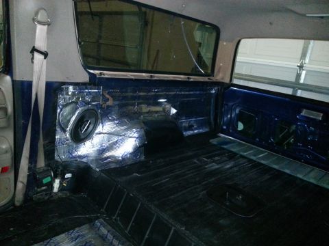 1994 Ford Bronco - Vehicle interior with sound deadening material and speaker installation visible.