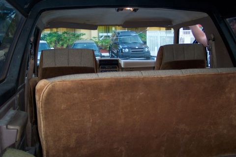 1986 Ford Bronco - Rear interior of a 1986 Ford Bronco, showing seats and dashboard area.