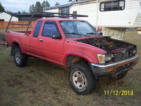 1991 Toyota Pickup/SR5 - Red 1991 Toyota Pickup/SR5 with a bed rack and hood open, parked in a grassy area.