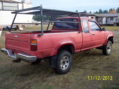 1991 Toyota Pickup/SR5 - This red 1991 Toyota Pickup/SR5 features a custom rack installed in the bed.