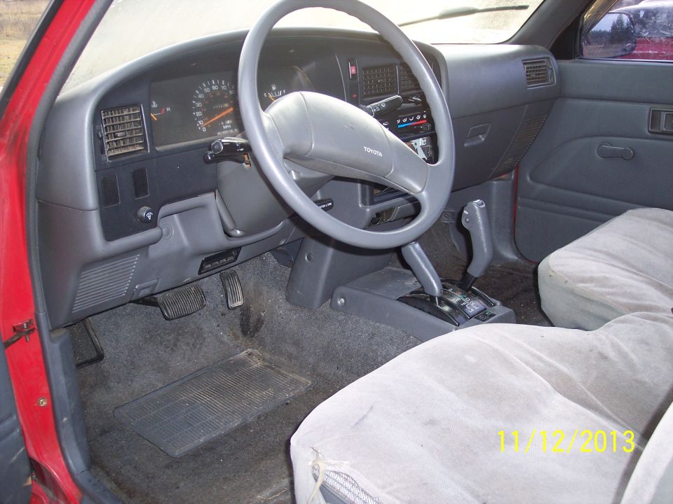 Interior of a 1991 Toyota Pickup SR5 showing dashboard, steering wheel, and seats