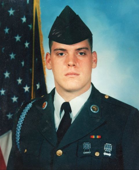 1982 Ford Bronco - Portrait of a soldier in uniform, with the American flag in the background.