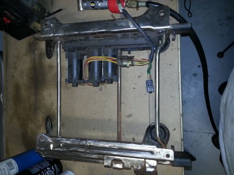 1994 Ford Bronco - Power seat base mechanism with motors and wiring harness visible.