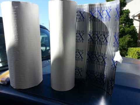 1994 Ford Bronco - Sound deadening material and paper rolls are placed on the hood of a vehicle.