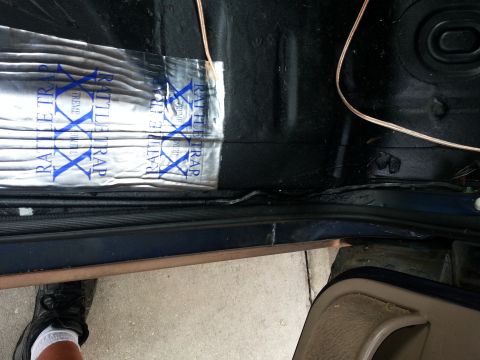 1994 Ford Bronco - Sound dampening material is being installed on the floor of a vehicle's interior.