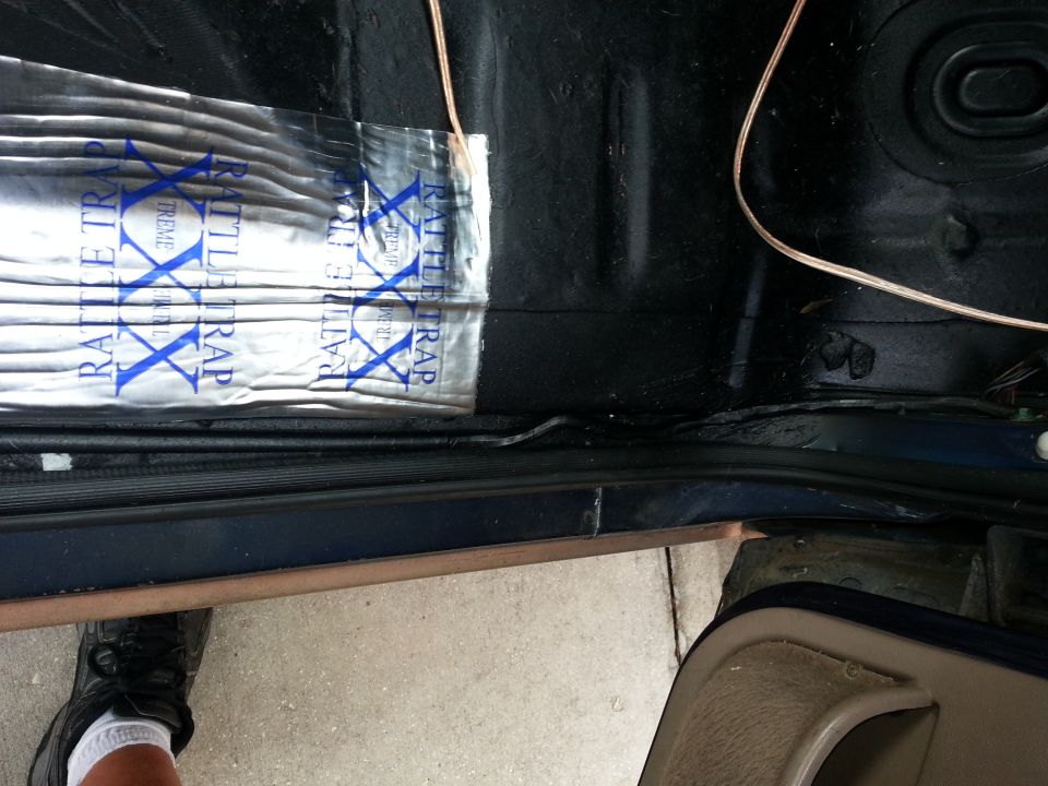 Sound deadening material applied to the floor of a vehicle interior