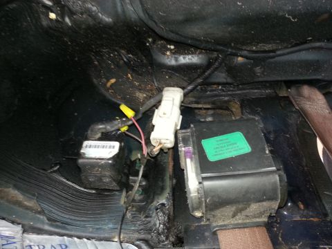 1994 Ford Bronco - This image shows a section of vehicle wiring and electronic modules located under the dashboard.