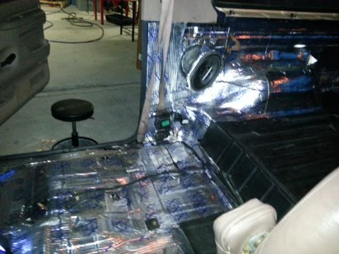 1994 Ford Bronco - Sound deadening material is being installed on the interior floor and door panels of a vehicle.