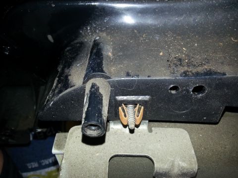 1994 Ford Bronco - Close-up of an automotive part, showing a plastic tube and a clip with a bolt.
