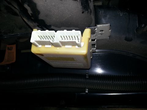 1994 Ford Bronco - A close-up view of an automotive electrical connector module with visible wiring connections.